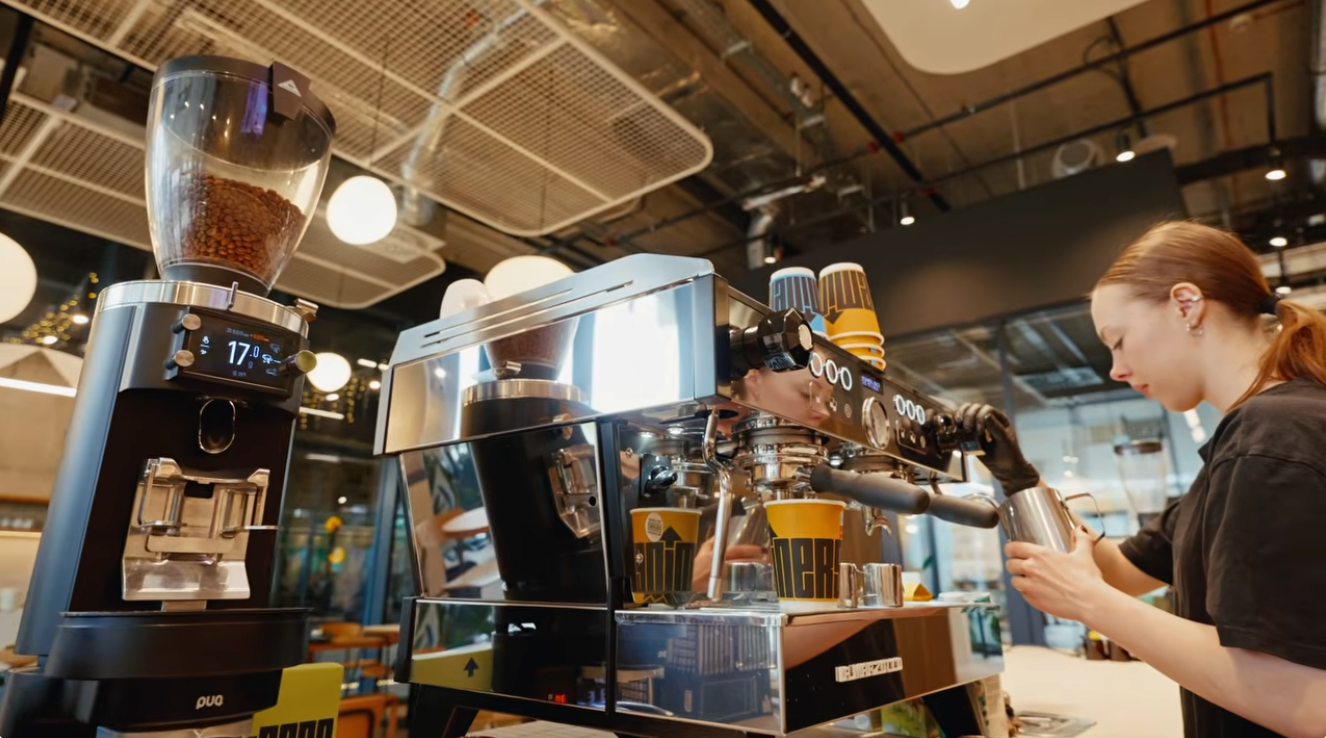 Barista using espresso machine and GbS grinder